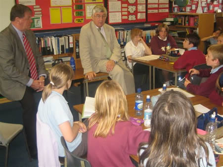Dr Francis speaking to Ynysmaerdy Primary School children with Education Cabinet Member Cllr John Rogers (left)
