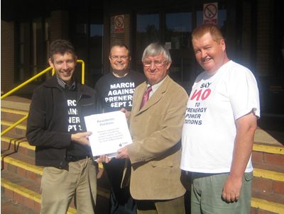 Hywel is presented with the petition by campaigners (l-r) Peter Wilson, Rev. Jeremy Bailey and Gareth Palmer