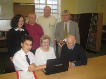 Dr Hywel Francis with pupils Joseph Devries and Sadie Jarrett, and 'silver surfers' who attend the class.